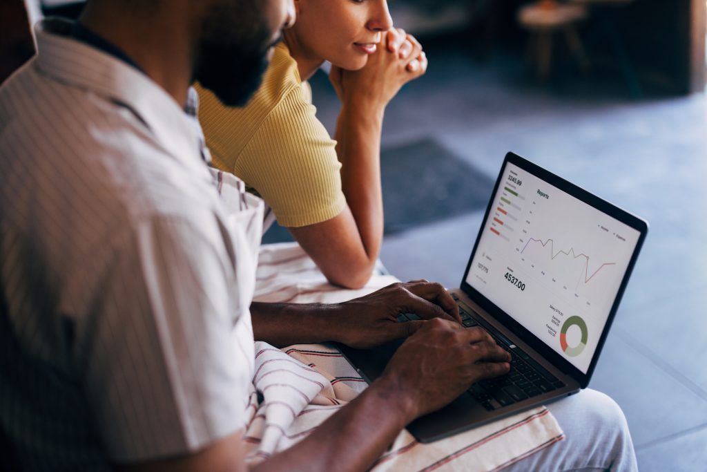 couple-reviewing-short-and-long-term-financial-goals-while-looking-at-laptop